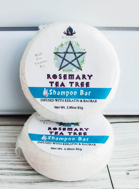 Photo of two round solid shampoo bars with white round labels, a blue band and pentagram.