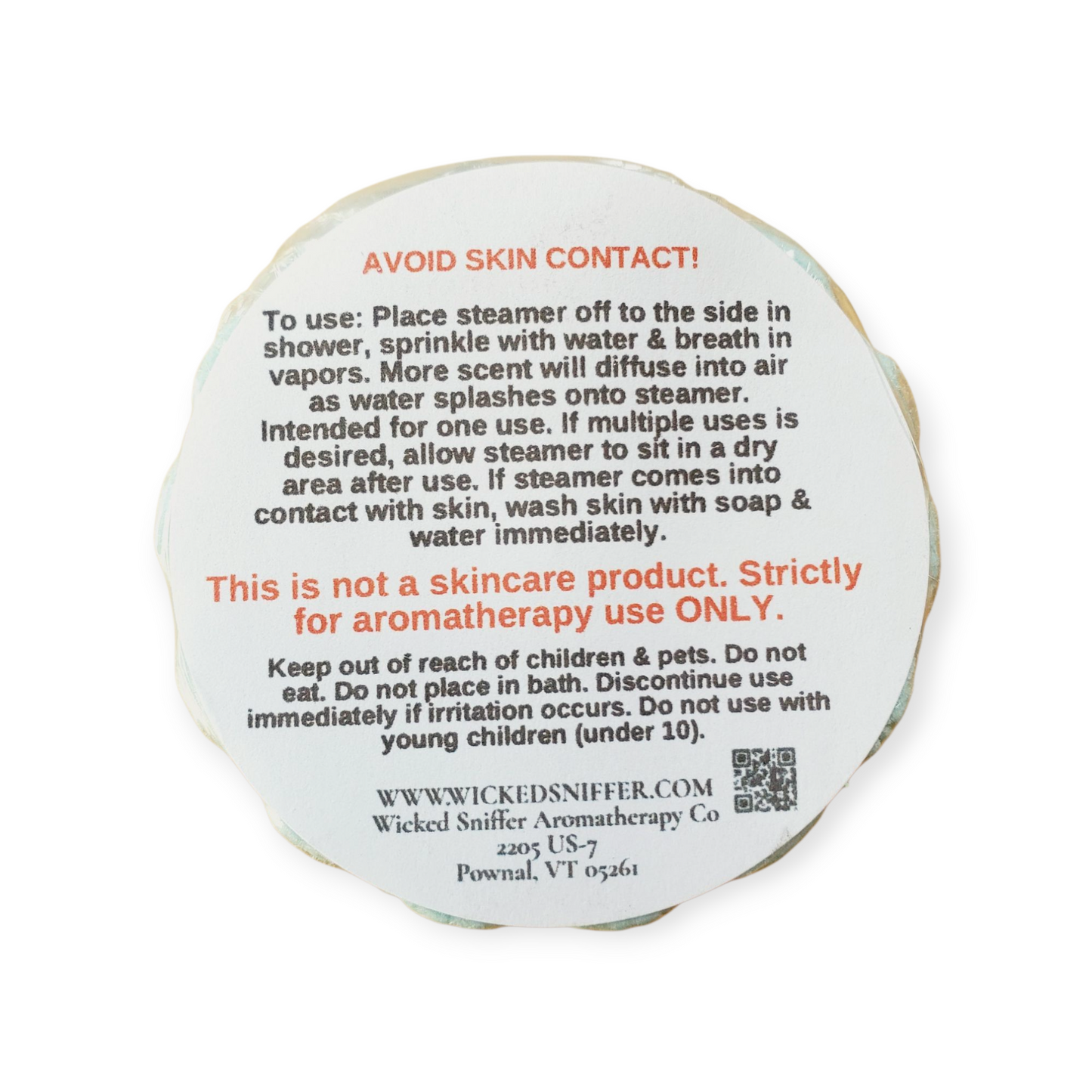 Round white product with black text and red warning on a white background