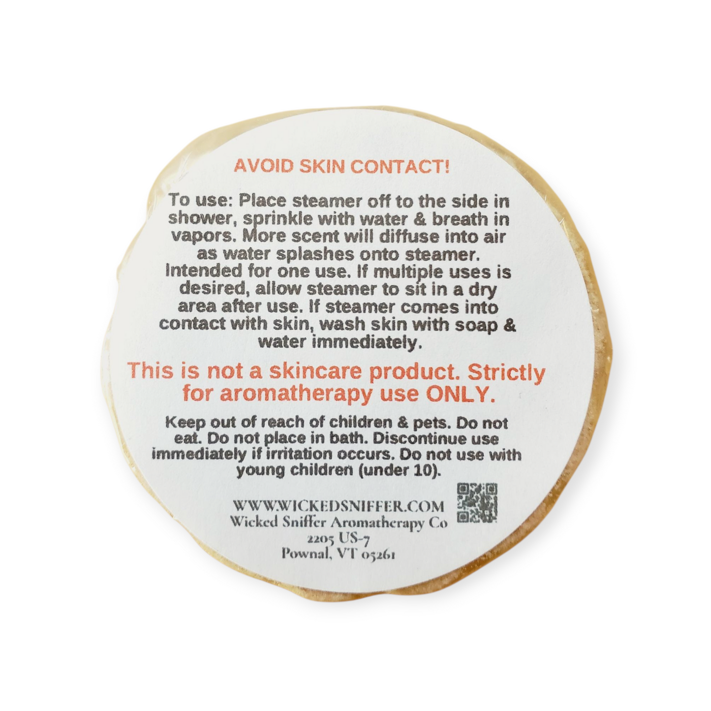 Round label with text and QR code on a white background
