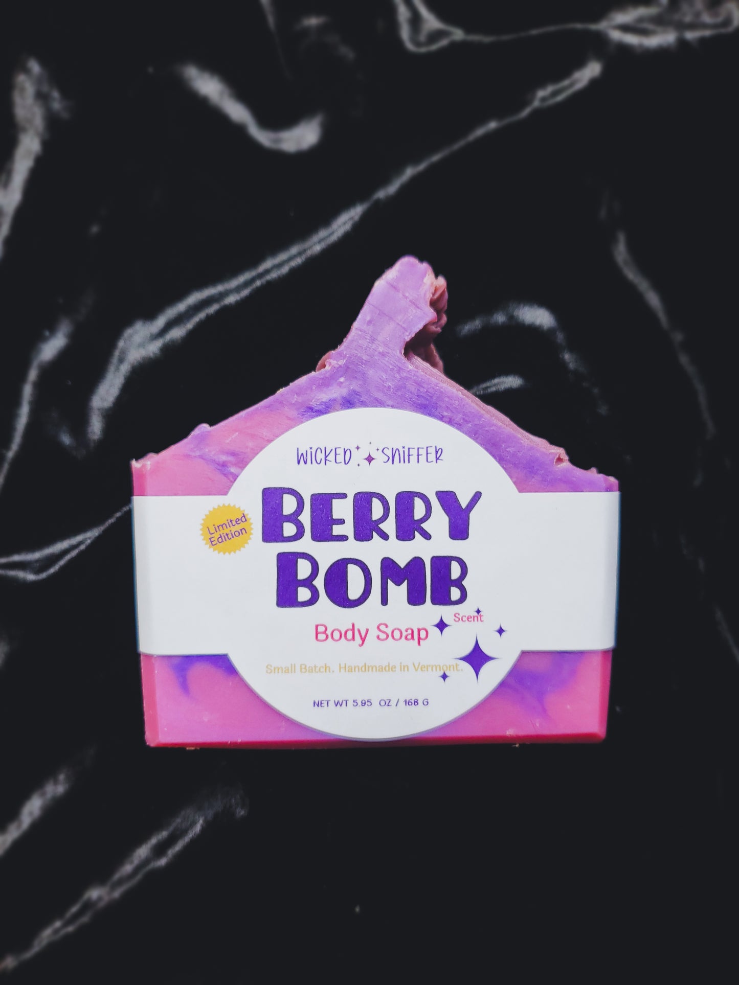 Berry Bomb body soap bar with a colorful design on a black background