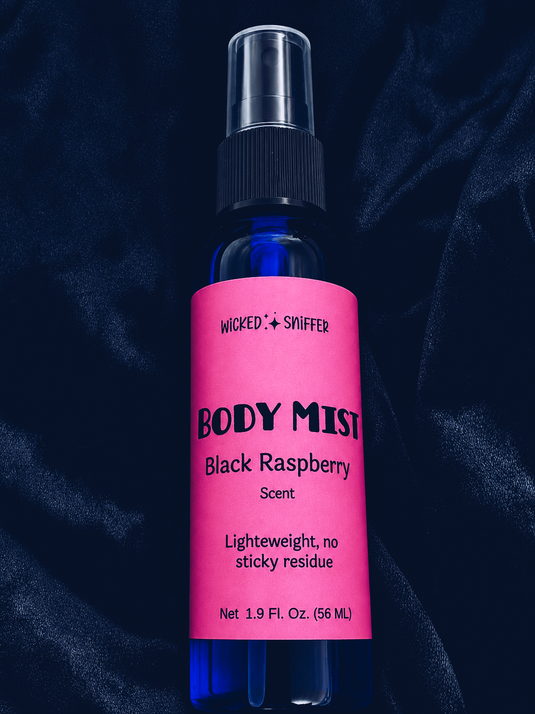 Body mist bottle with pink label on a dark background
