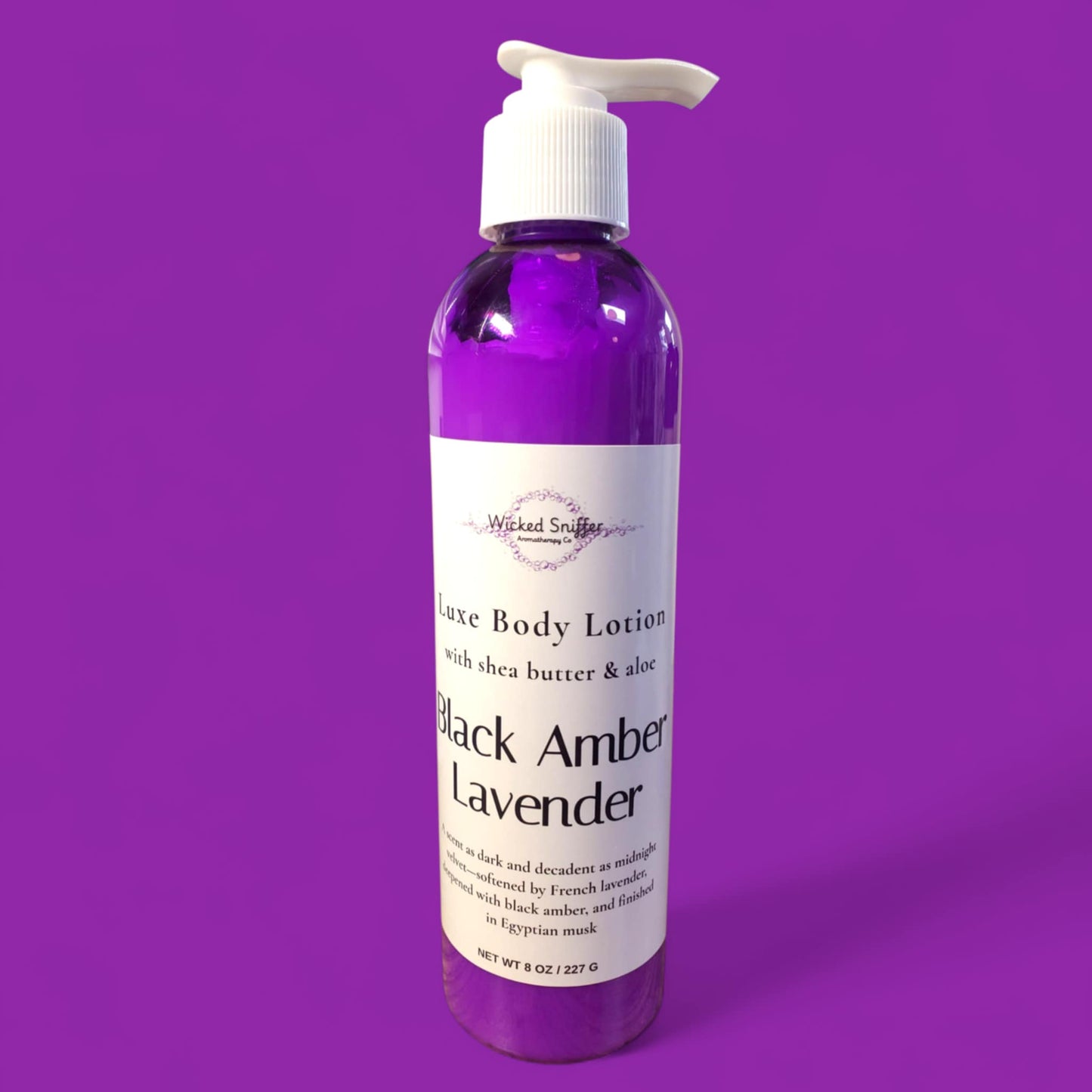 Bottle of Black Amber Lavender body lotion on a purple background