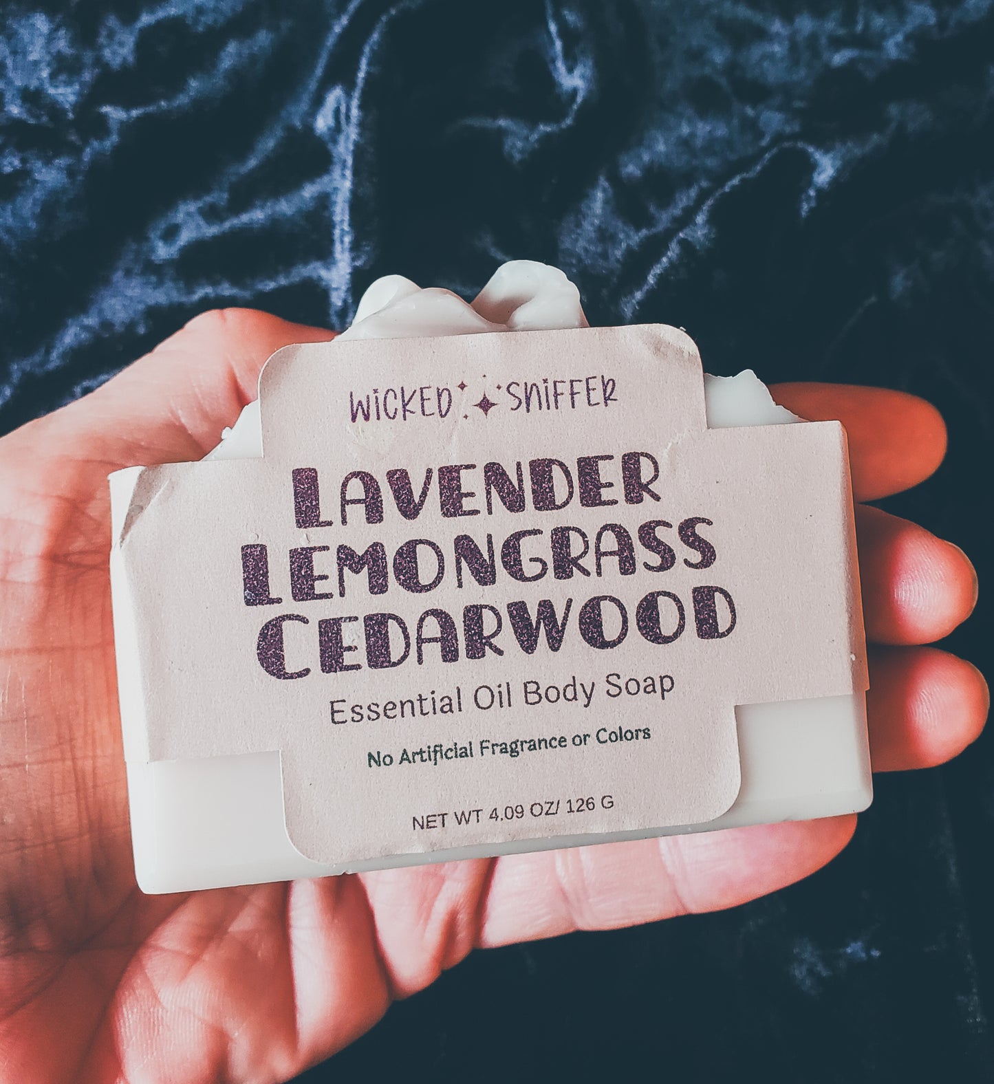 Hand holding Tan soap on a black background