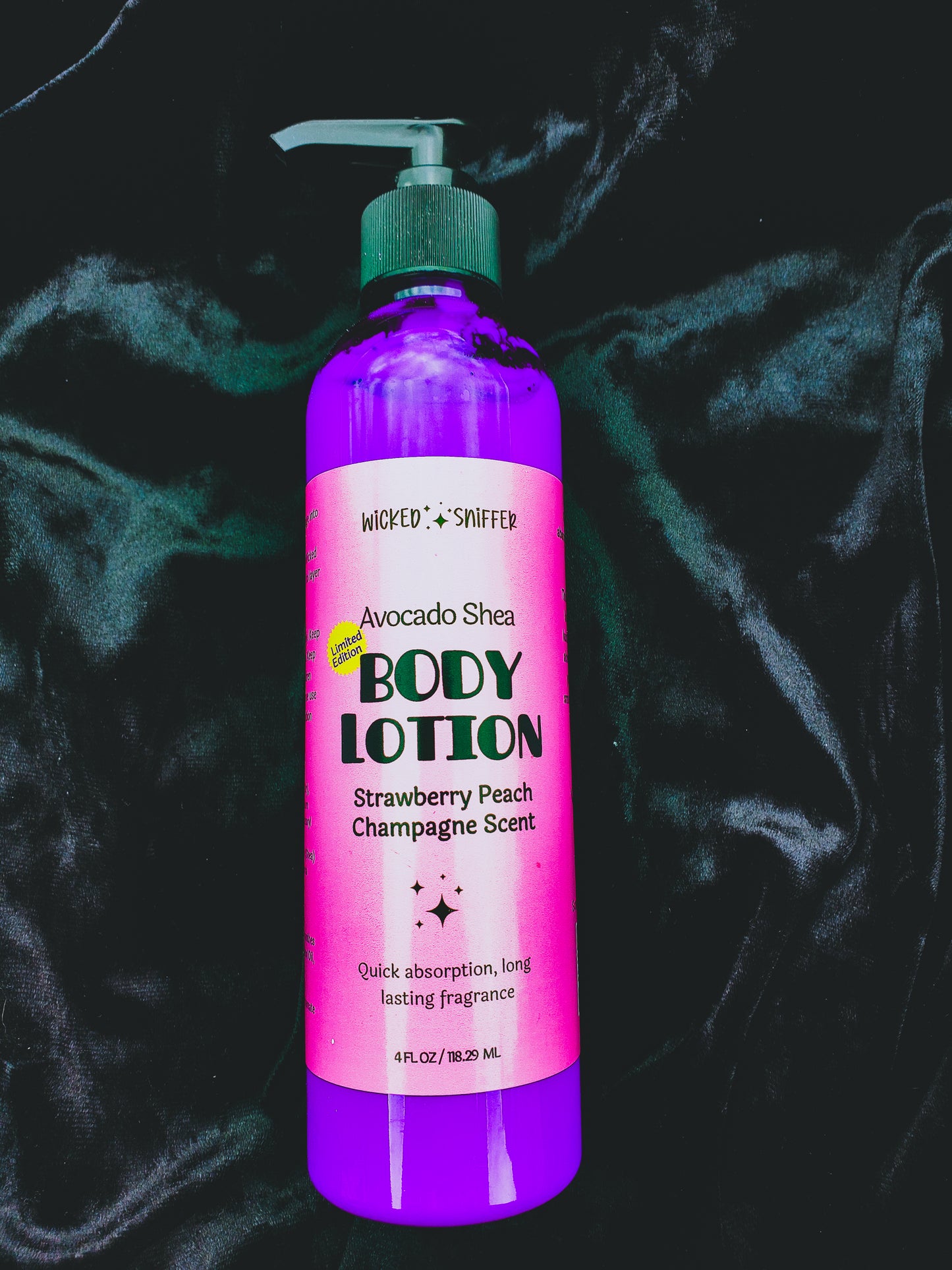 Body lotion bottle with pink label on a dark background