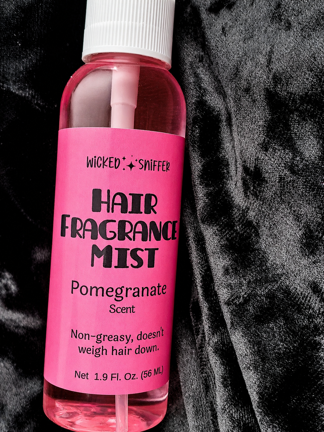 Pink bottle of Hair Fragrance Mist with a black and white background