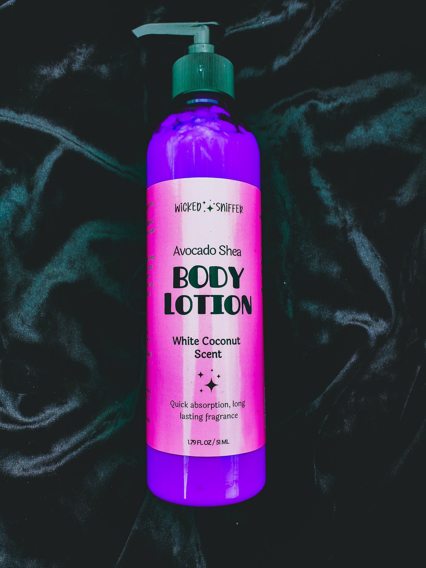 Purple body lotion bottle with pink label on a dark textured background