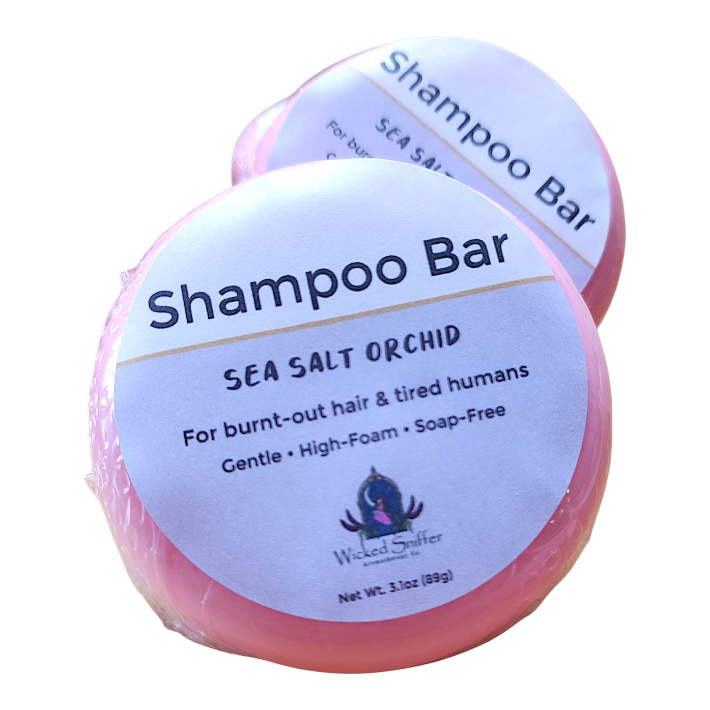 Two shampoo bars with labels on a white background
