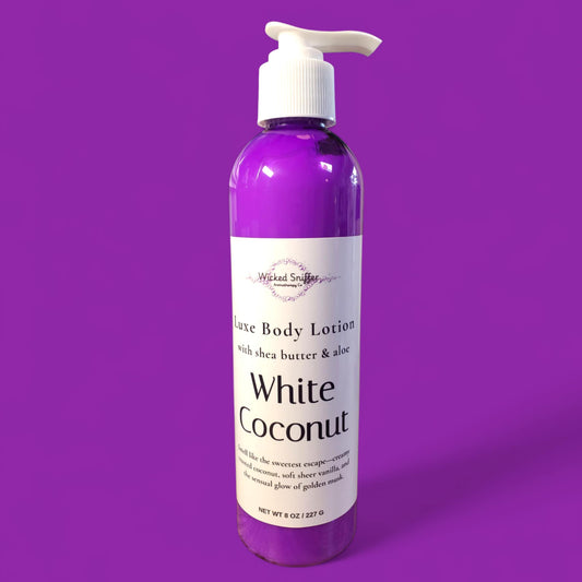 Bottle of White Coconut body lotion on a purple background