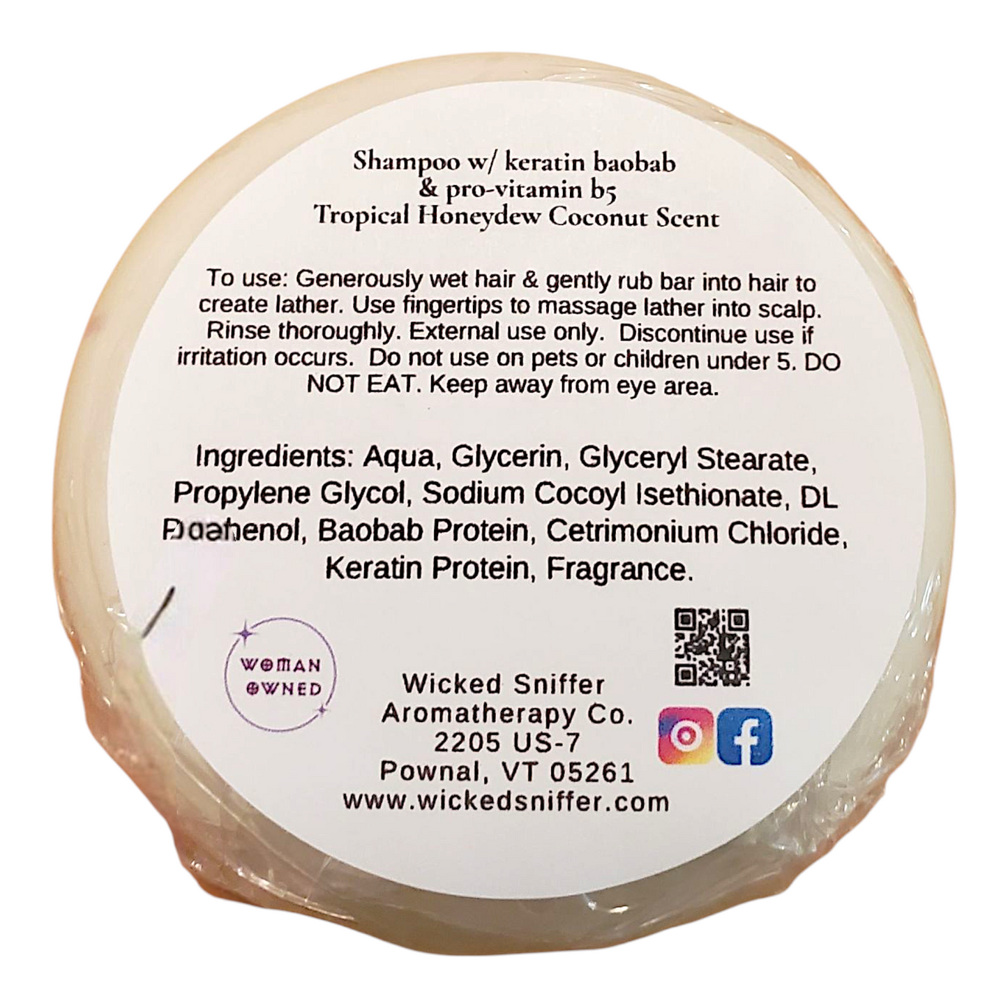 Bar of shampoo with a label detailing usage, ingredients, and branding on a white background