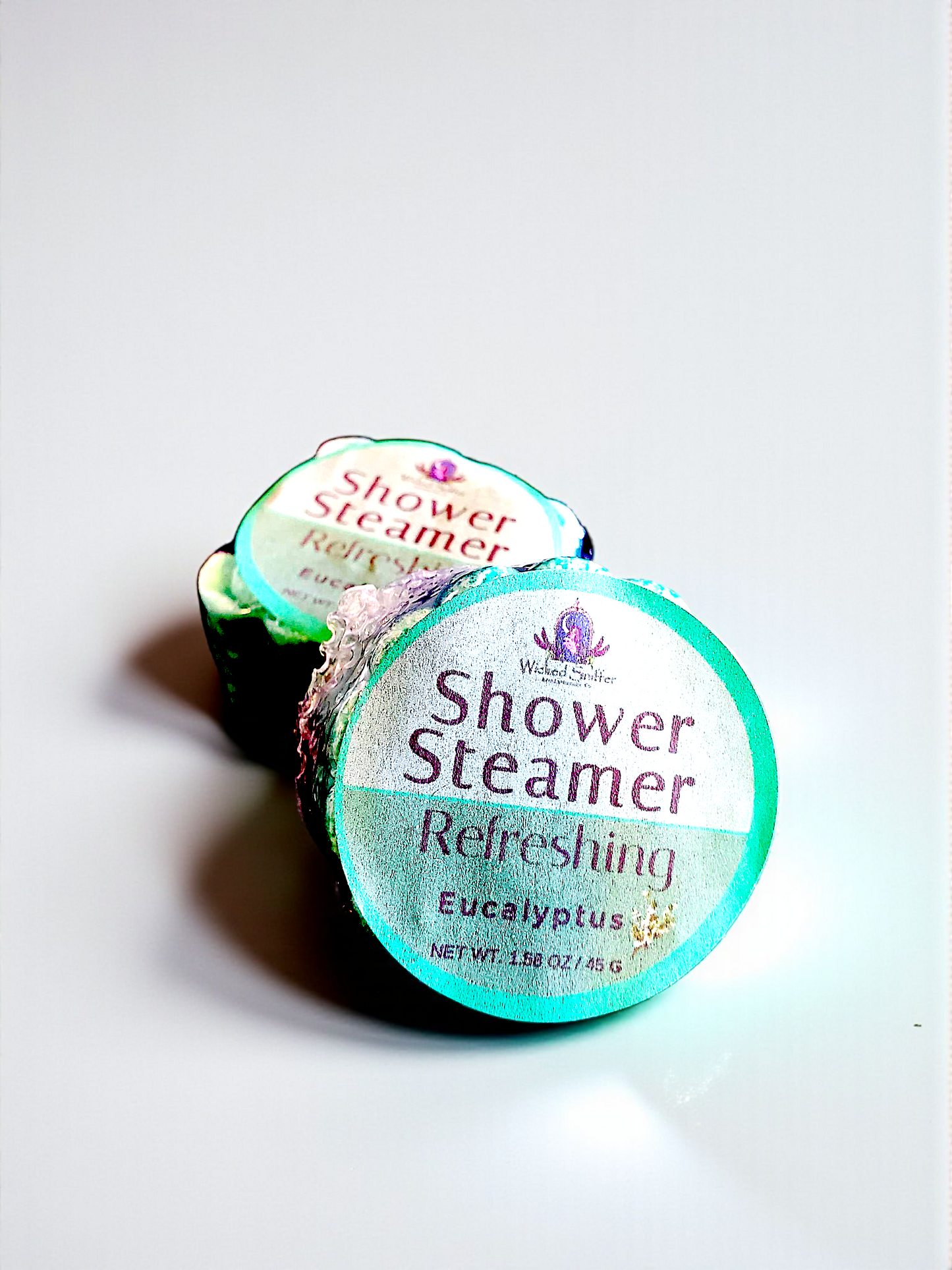 Two shower steamers labeled 'Refreshingly Eucalyptus' on a light gray background