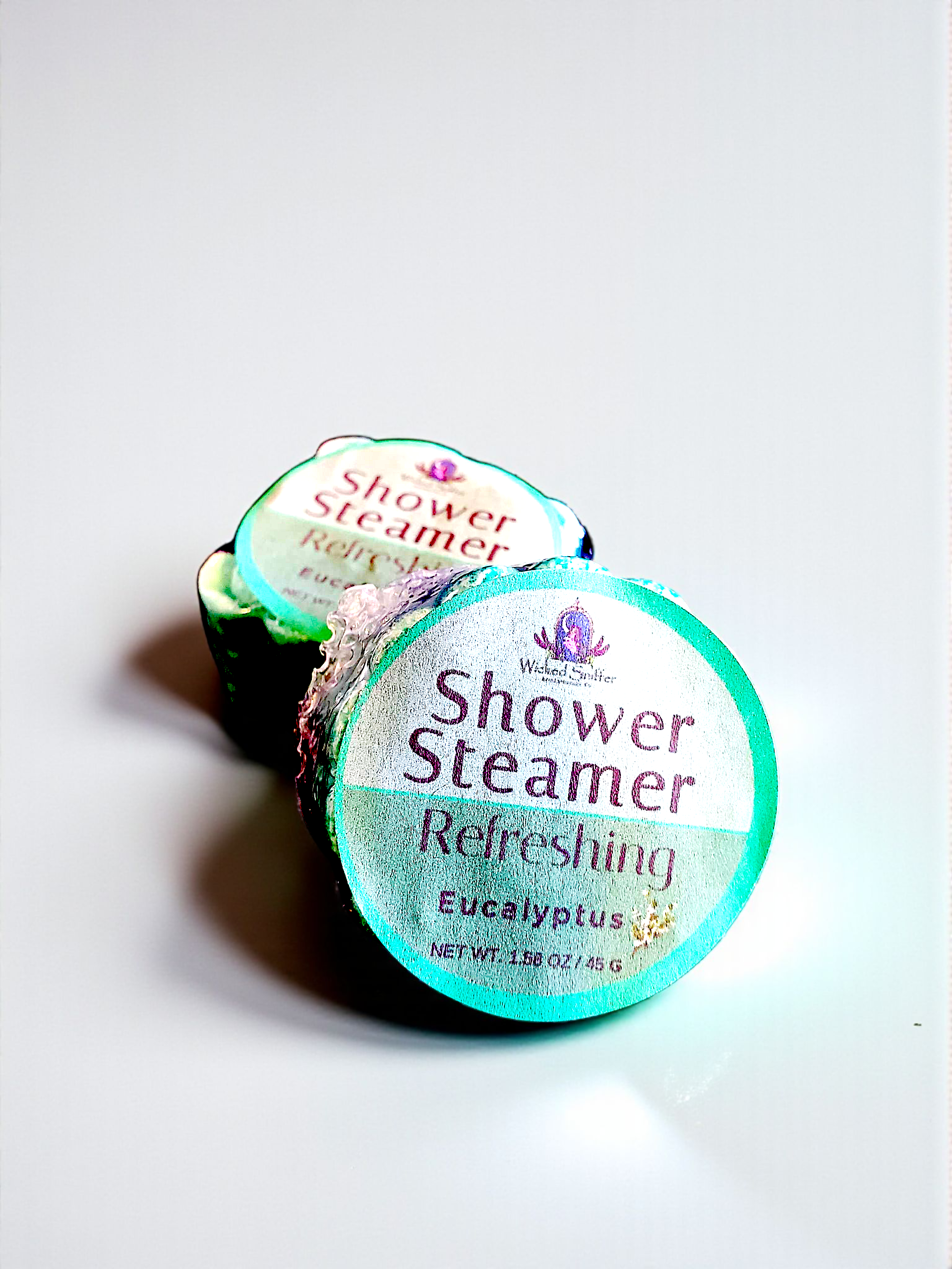 Two shower steamers labeled 'Refreshingly Eucalyptus' on a light gray background
