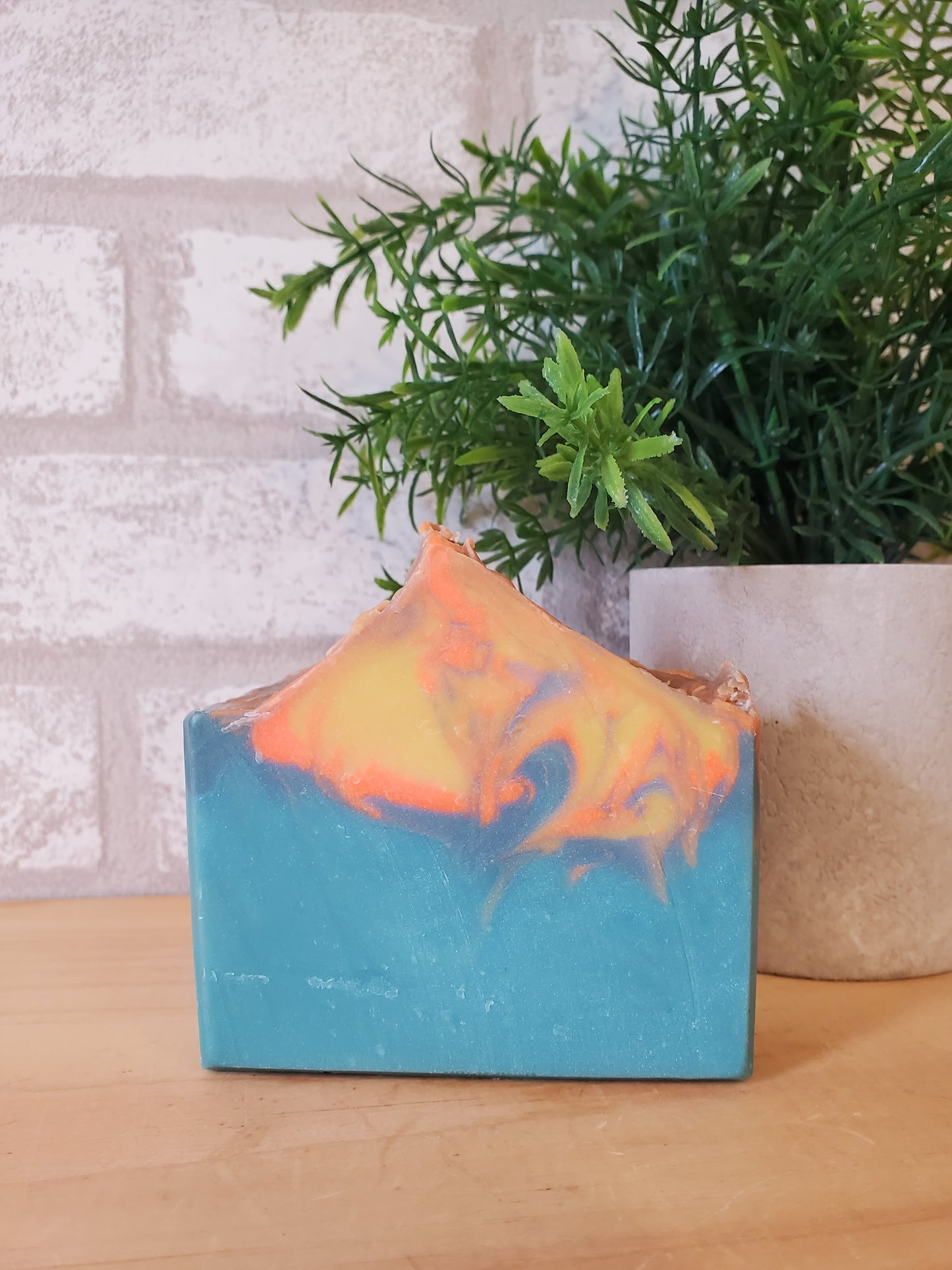 Bar of handmade cold process, soap with 'Sunset' label on a light background made in Vermont 