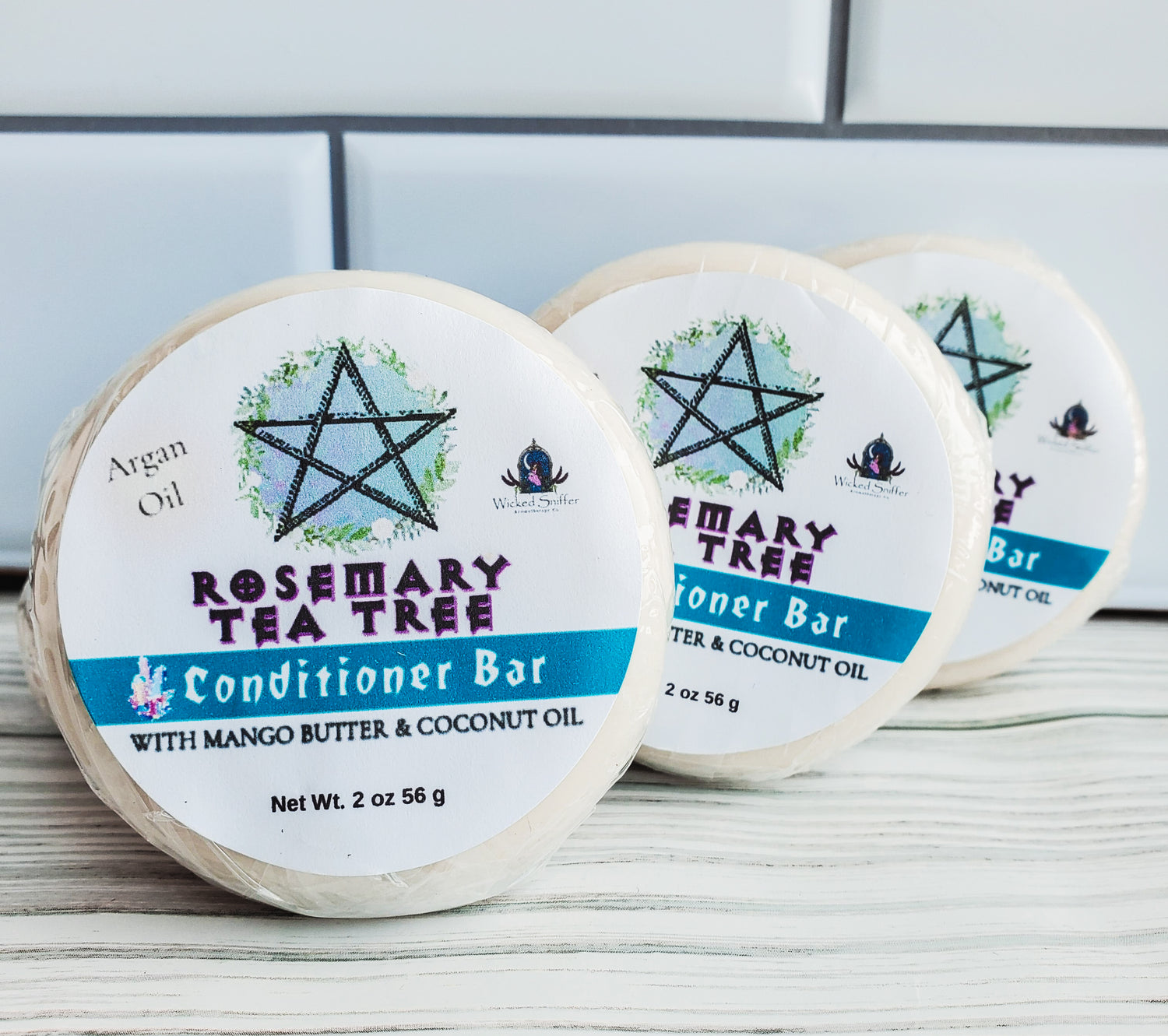 Picture of three round conditioner bars with a white label, blue band and a pentagram.