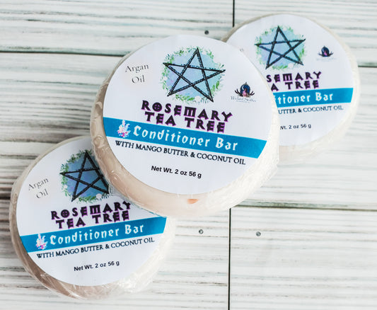 Photo of three round solid conditioner bars with white round labels, a blue band and pentagram.