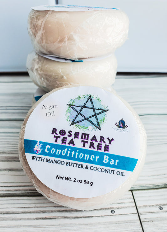 Photo of three round solid conditioner bars with white round labels, a blue band and pentagram.