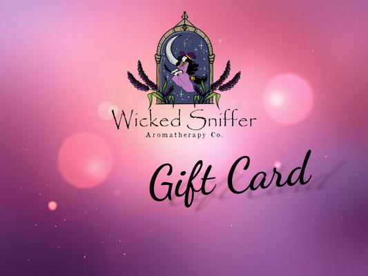 Wicked Sniffer Aromatherapy Co. gift card design with a mystical design on a pink and purple gradient background.