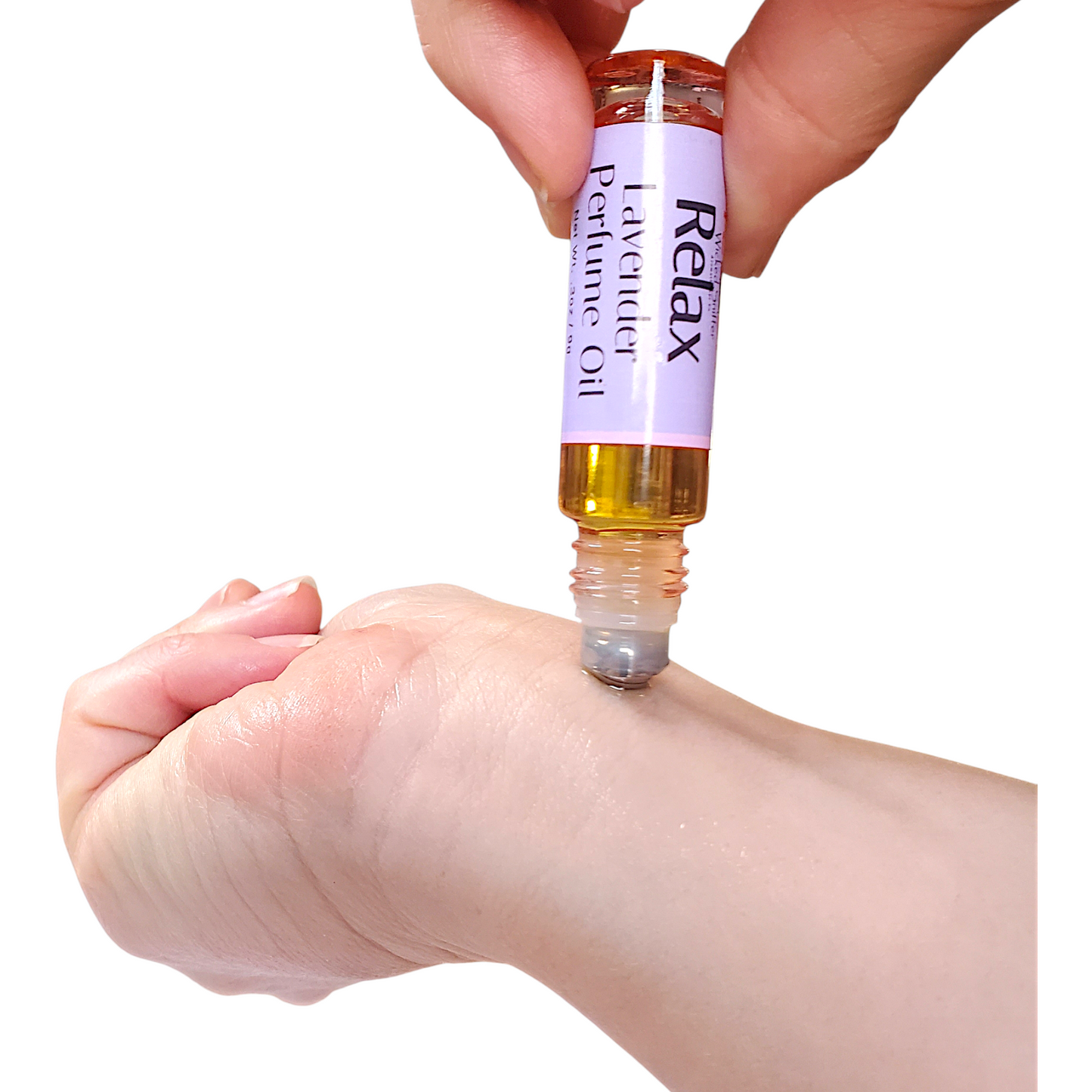 Hand applying lavender perfume oil to wrist with a white background