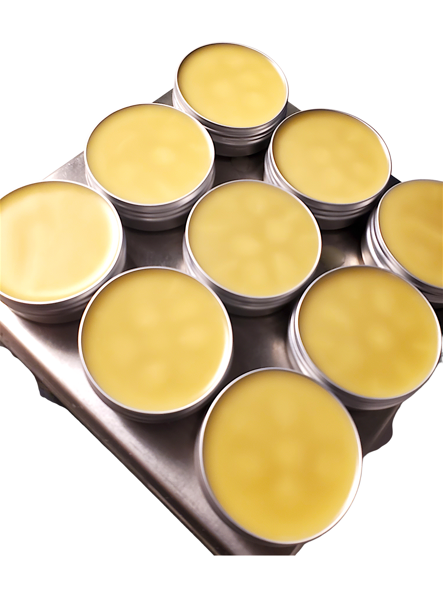 Metal tin with yellow balm on a white background