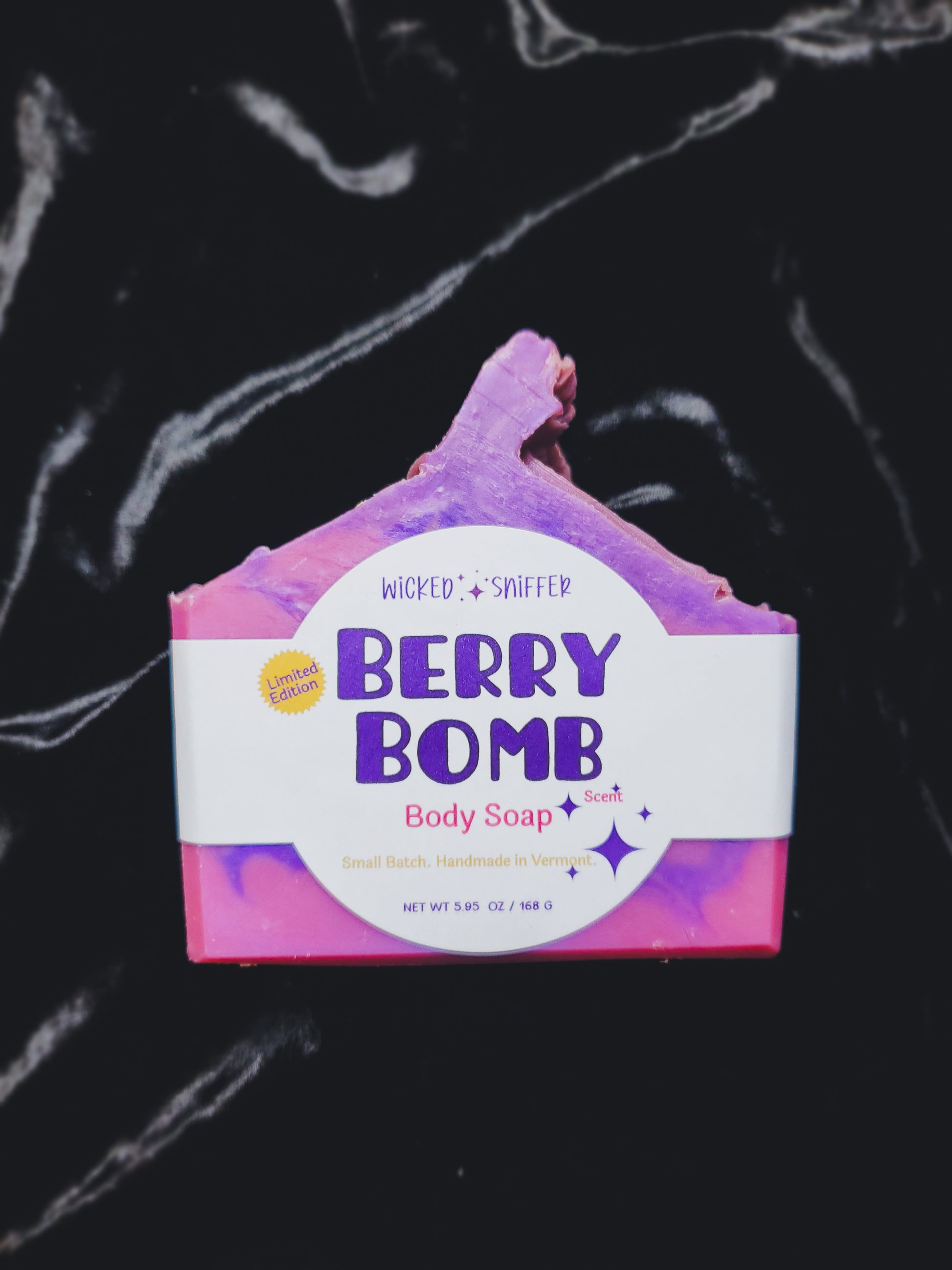 Berry Bomb body soap bar with a colorful design on a black background