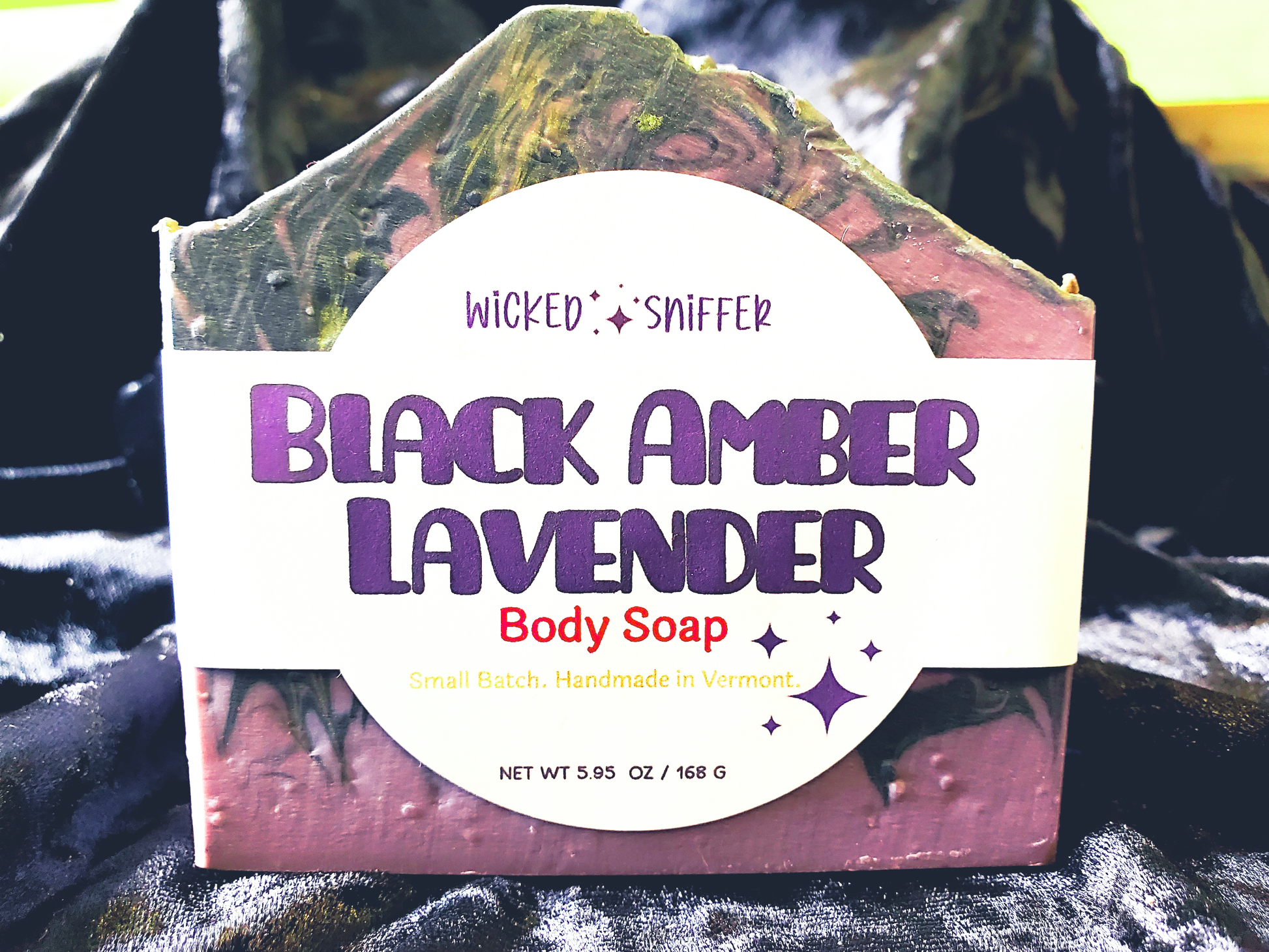 Bar of handmade Black Amber Lavender cold process soap on a dark background made in Vermont 