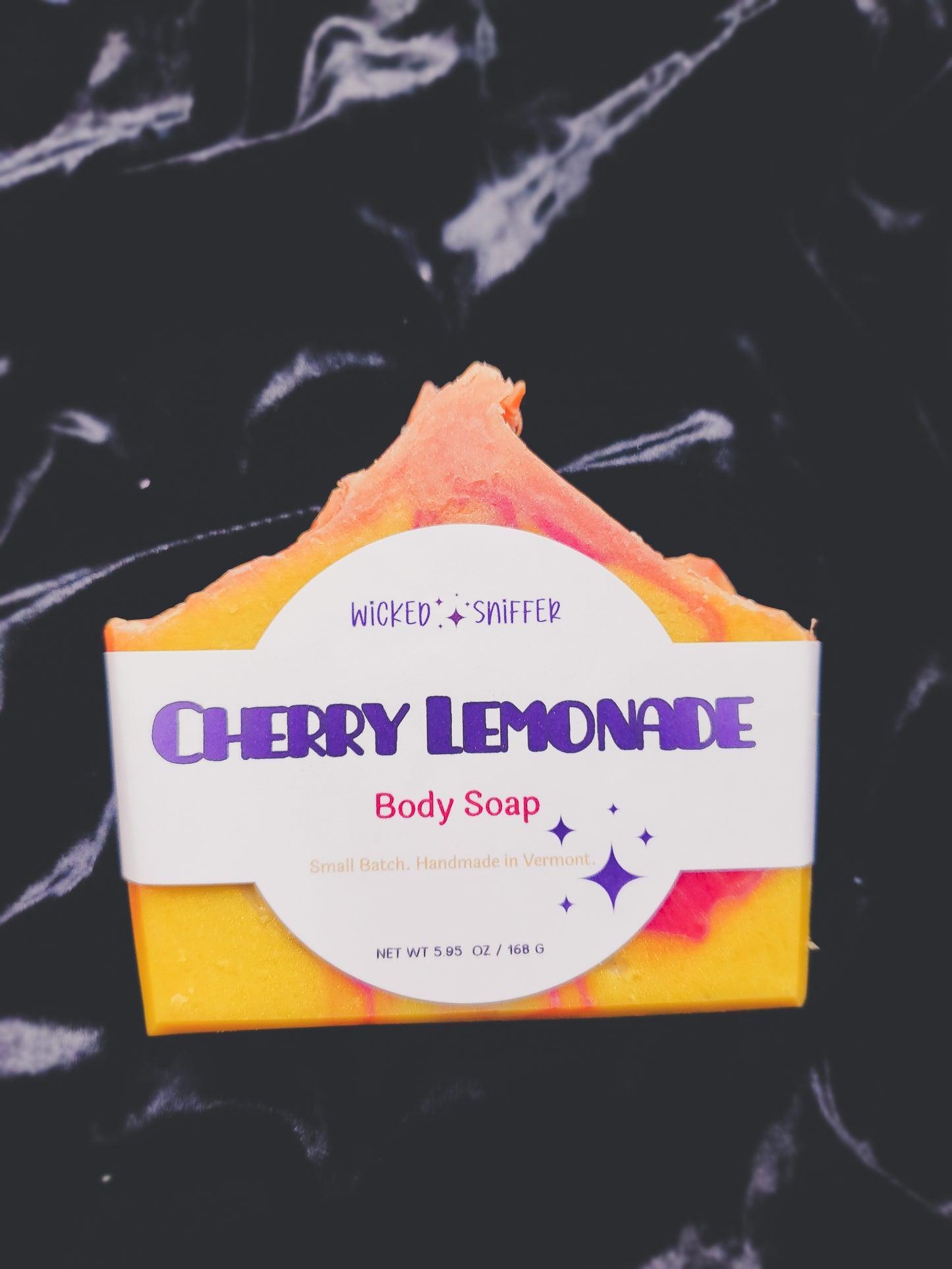 Bar of soap with 'Cherry Lemonade' label on a dark background