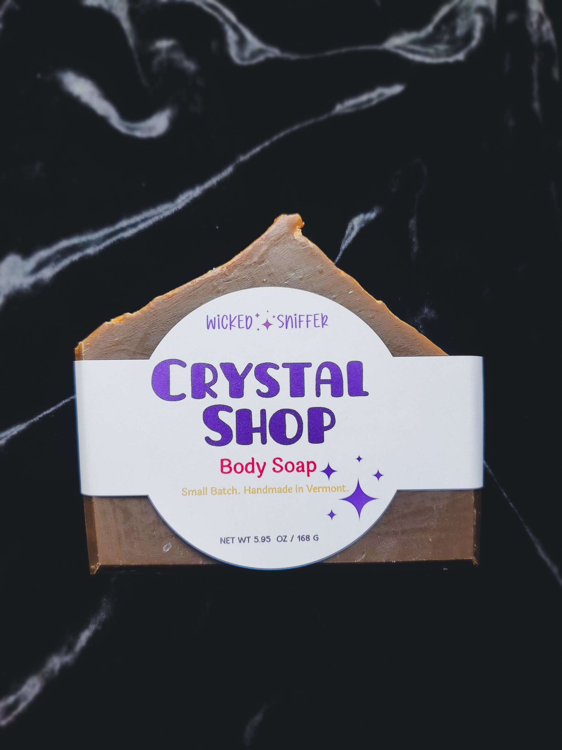 Bar of soap with a 'Crystal Shop' label on a dark background