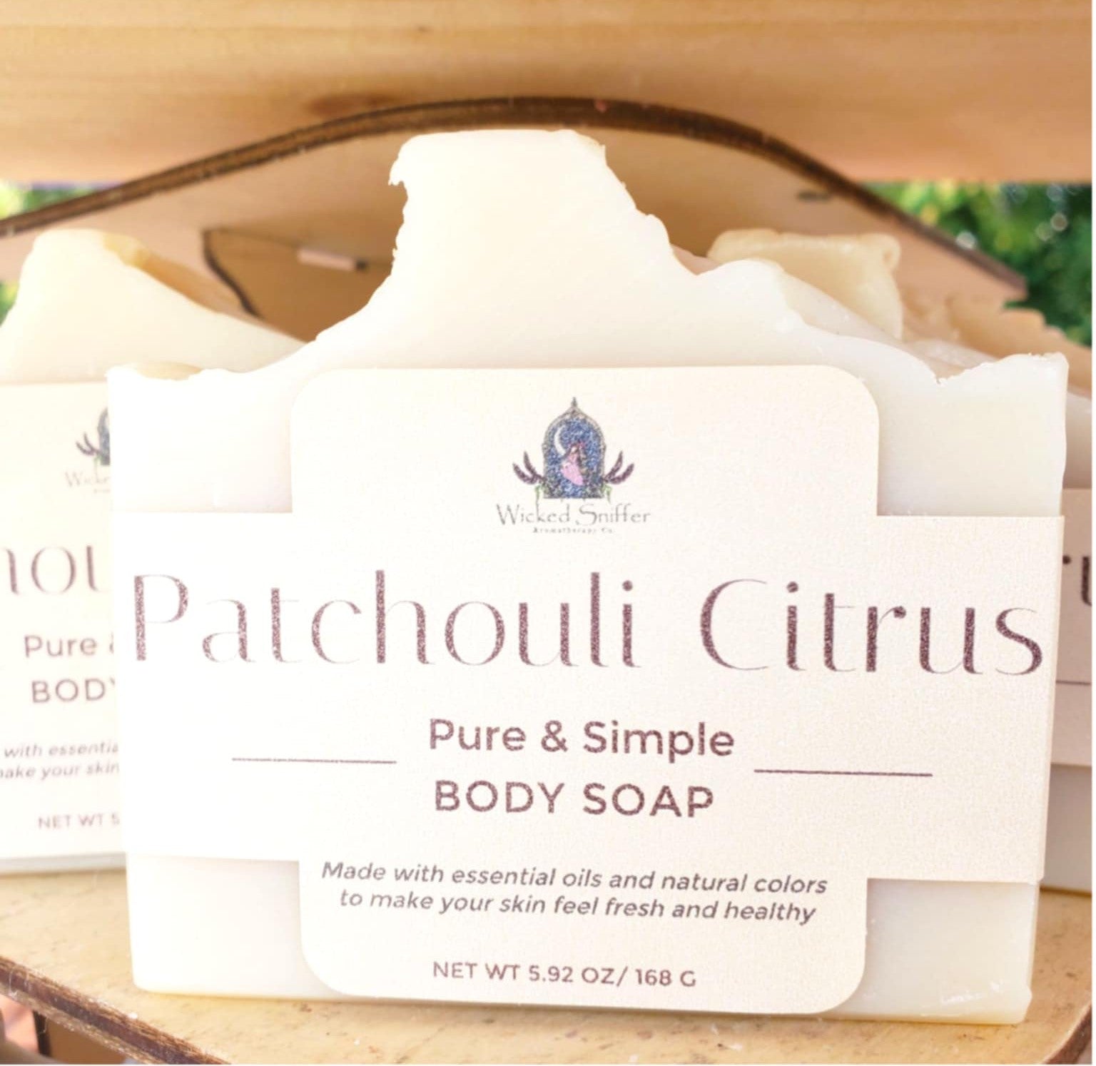 Patchouli Citrus body soap with a label on a wooden surface
