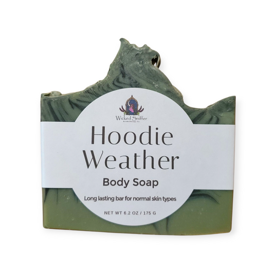 Green bar of soap with a label on a white background