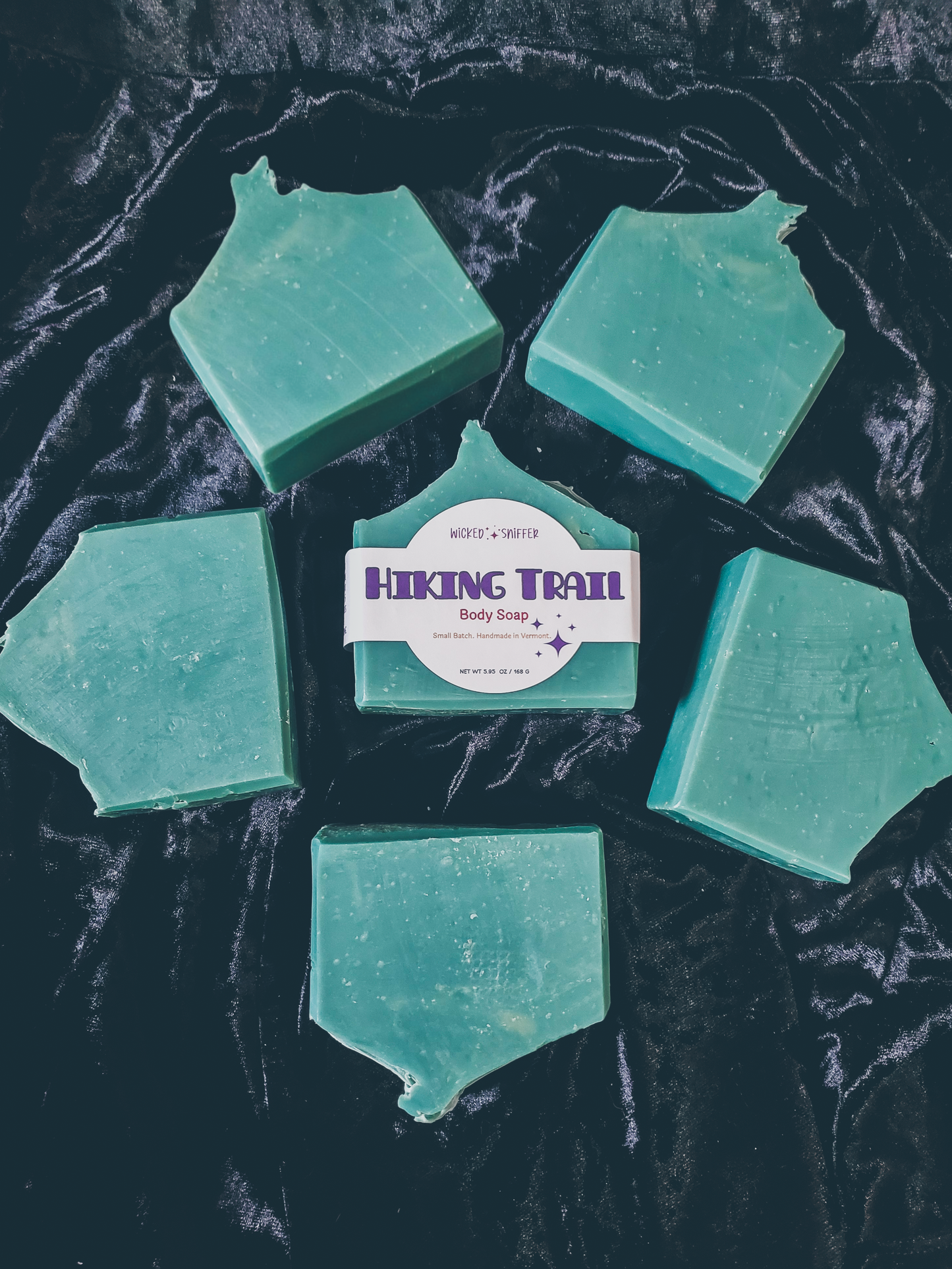 Bars of handmade green Hiking Trail cold process soap  on a dark background made in Vermont 