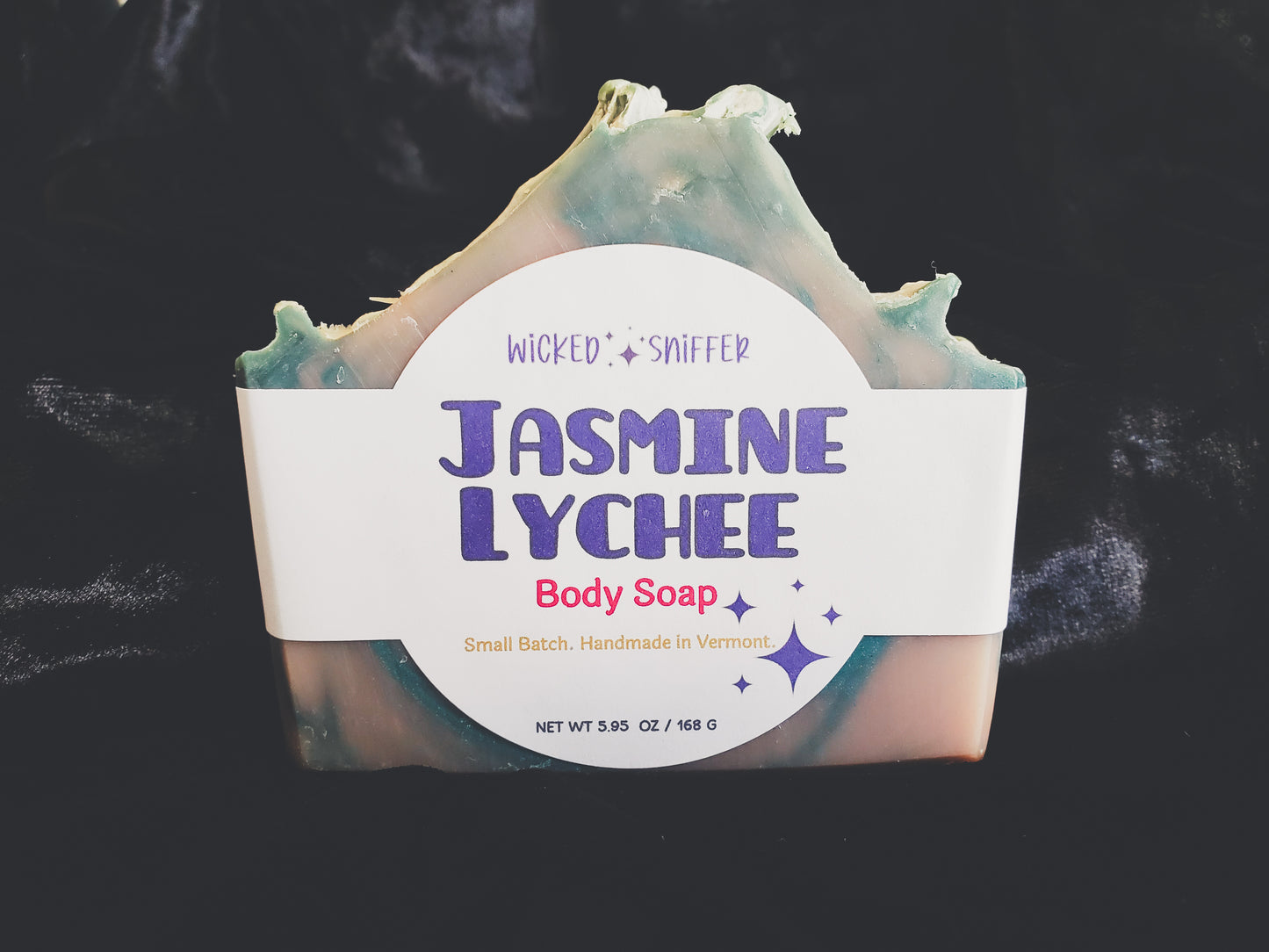 Bar of handmade Jasmine Lychee cold process soap  on a dark background made in Vermont 