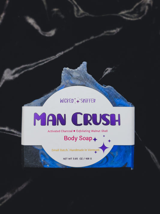 Blue bar of soap with a white label on a black background