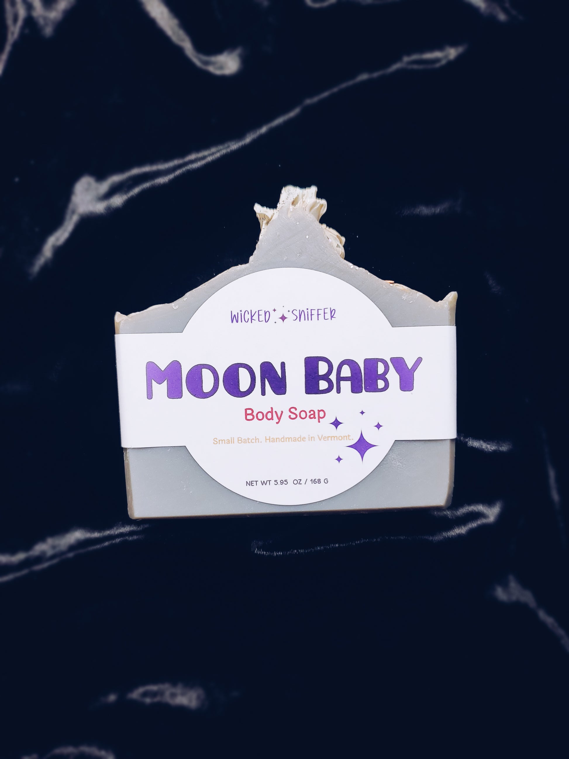 Moon Baby body soap with a label on a dark background