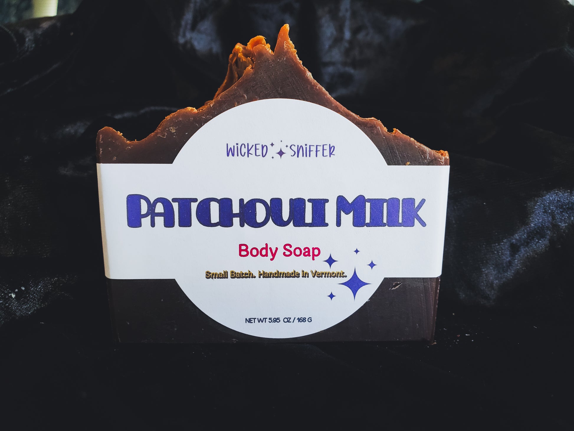 Bar of handmade Patchouli Milk cold process soap  on a dark background made in Vermont 