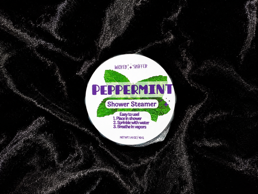 Peppermint shower steamer with label on a black textured background