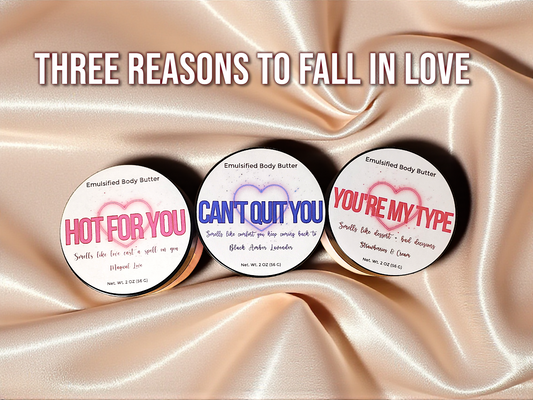 Three round body butter containers with text on a satin background