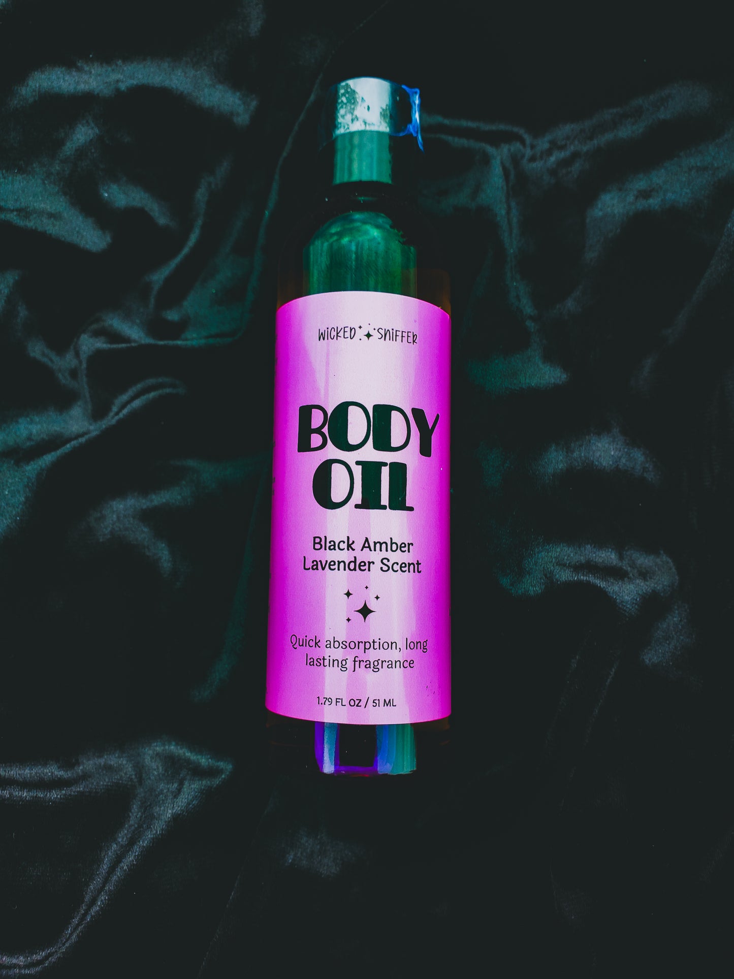 Bottle of Body Oil with purple label on a dark background