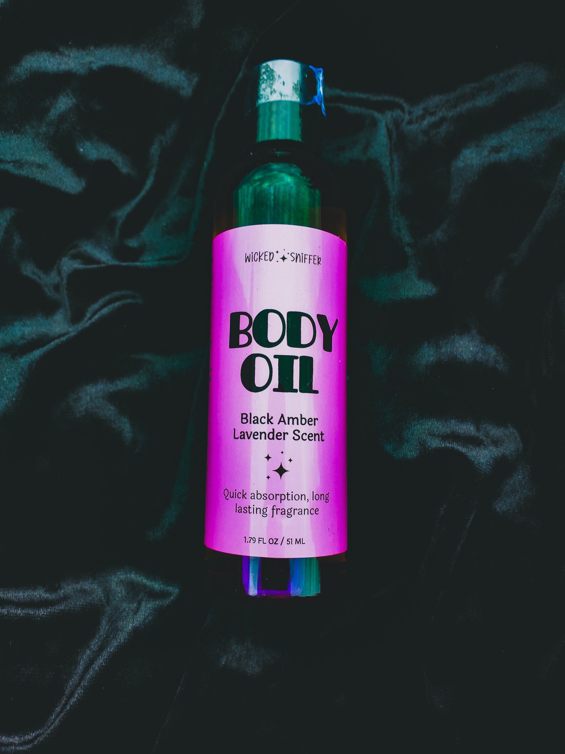 Bottle of Body Oil with purple label on a dark background