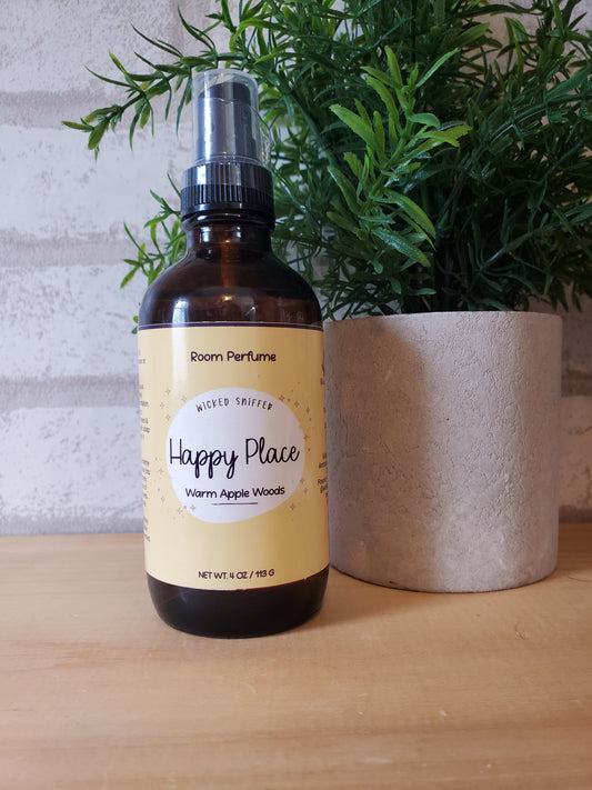 Bottle of 'Happy Place' product with a label on a wooden surface next to greenery