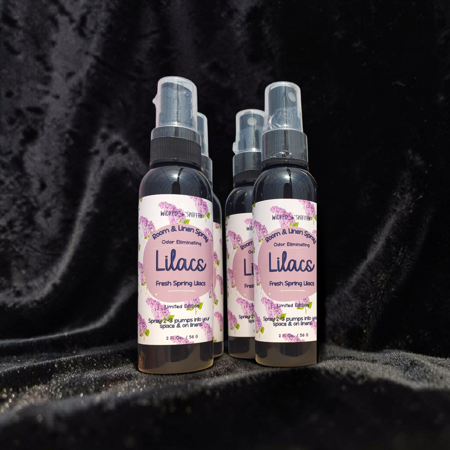 Black bottles with white and purple labels on a black background