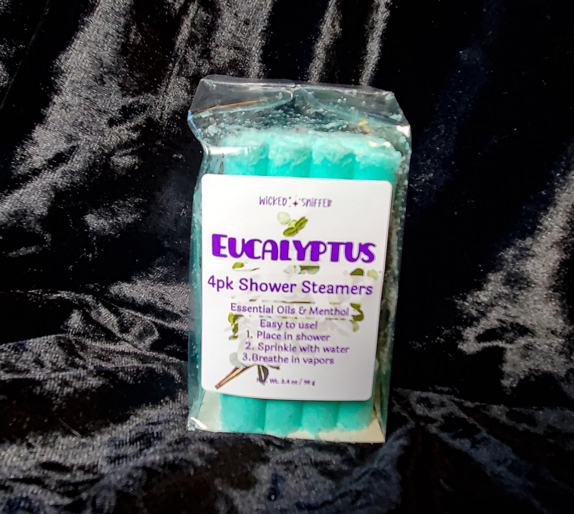 Pack of Eucalyptus shower steamers on a textured black background