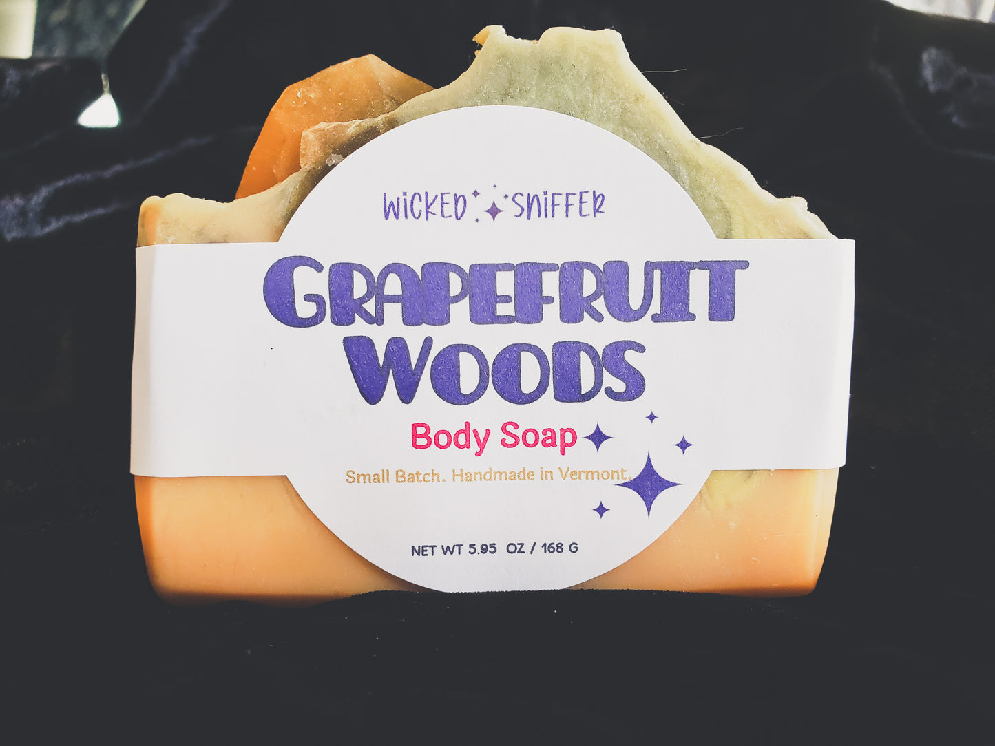 Grapefruit Woods body soap with a label on a black background