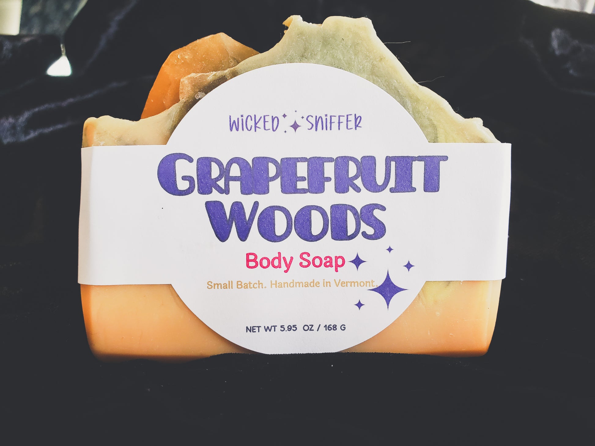 Grapefruit Woods body soap with a label on a black background