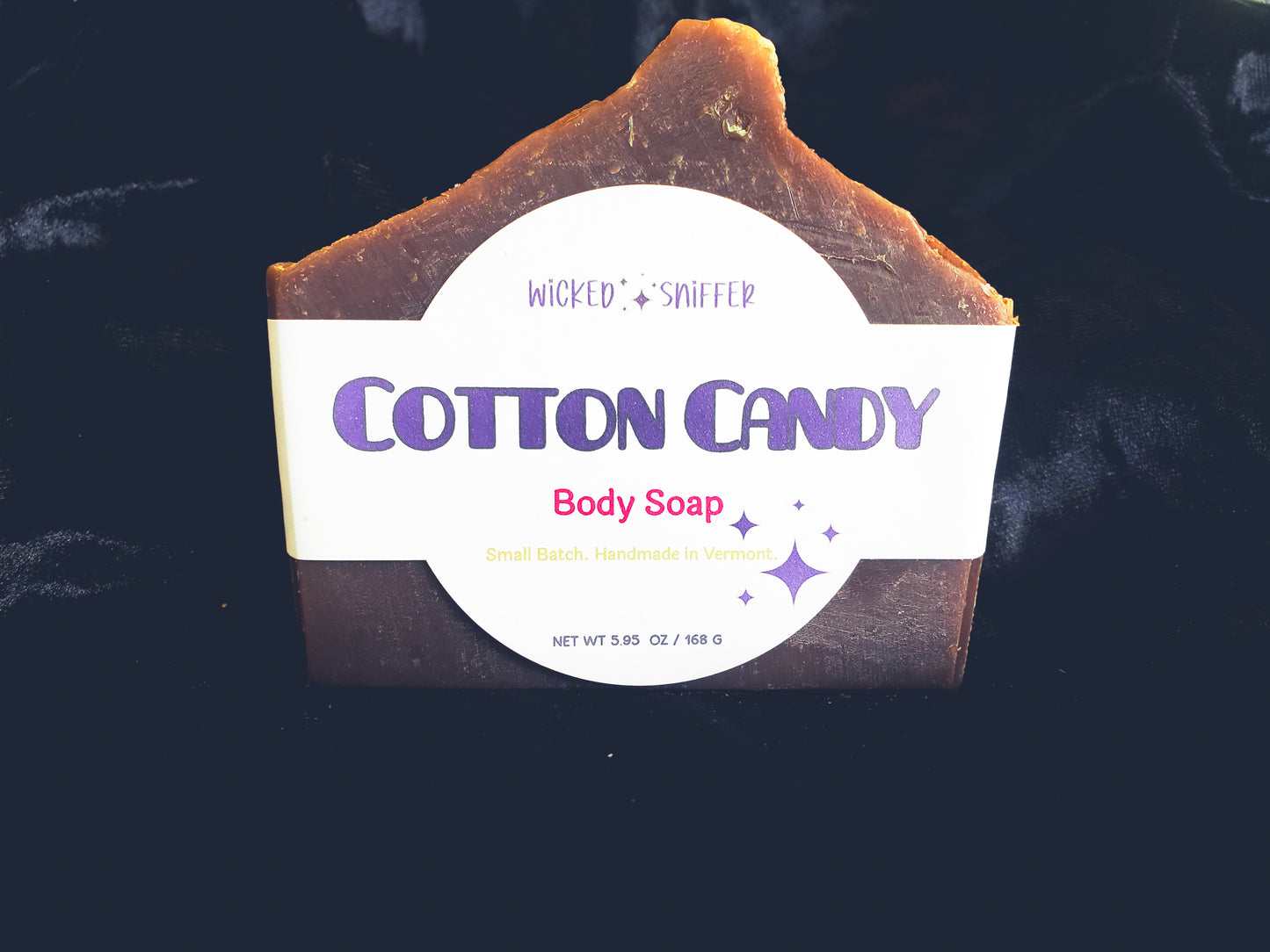 Bar of handmade Cotton Candy cold process soap  on a dark background made in Vermont 