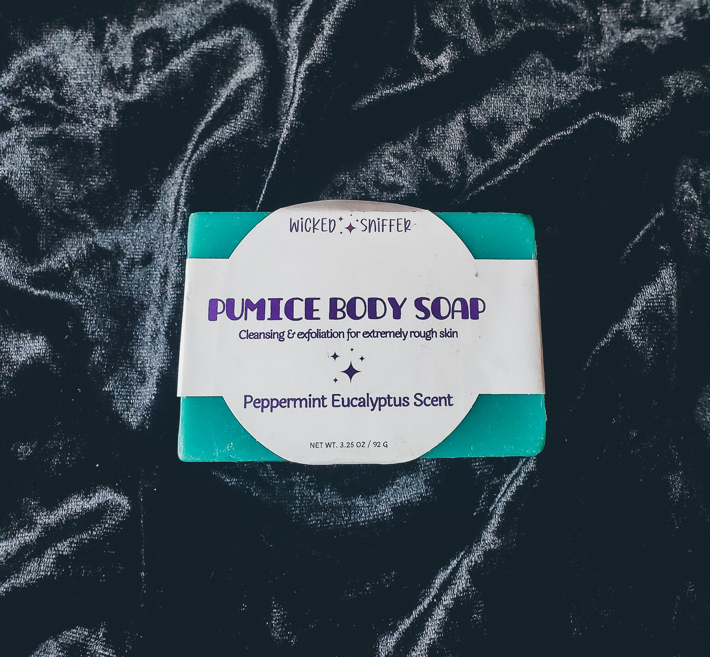 Blue soap with a white label on a black background