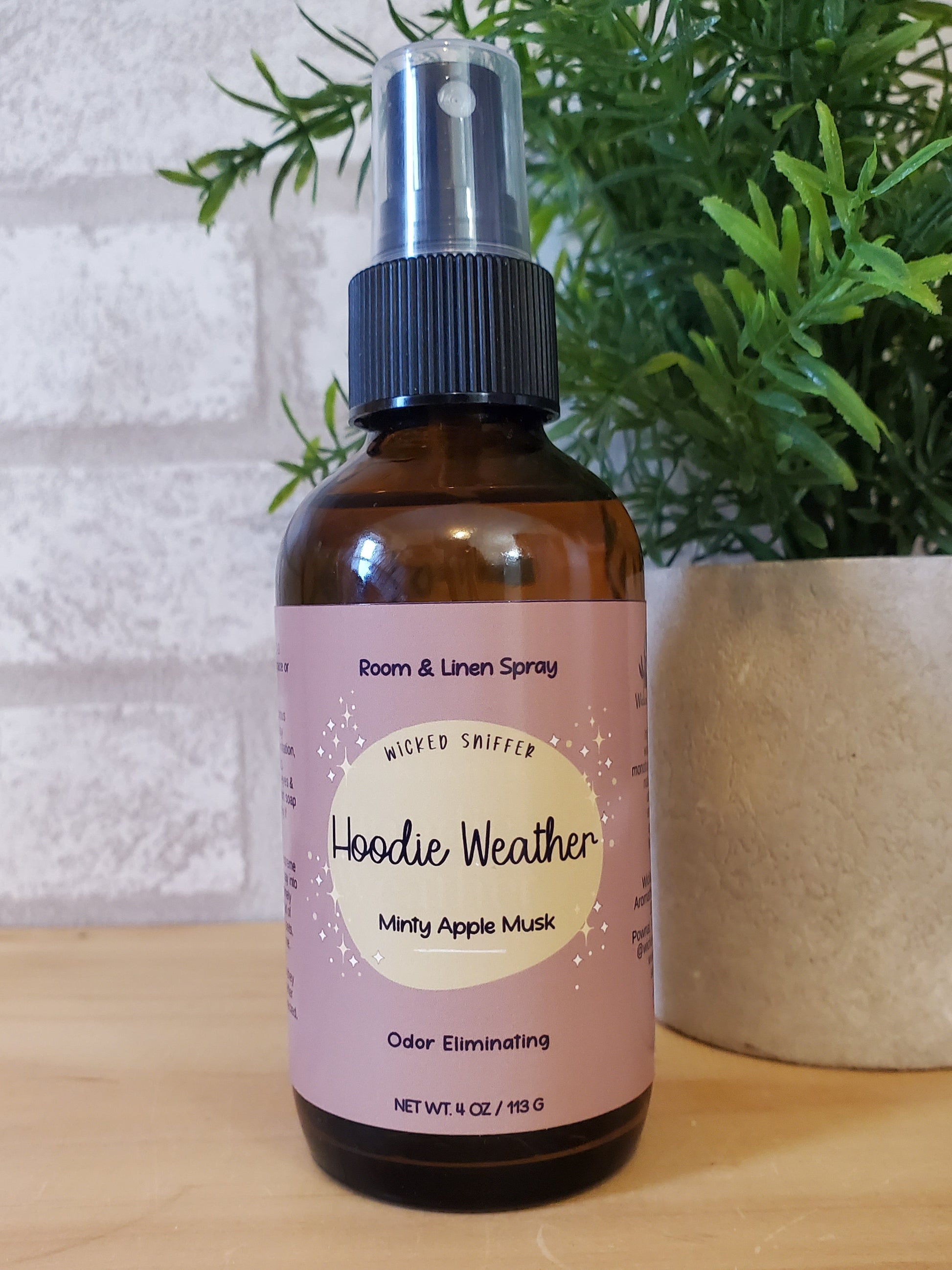 Bottle of room spray with a label on a wooden surface