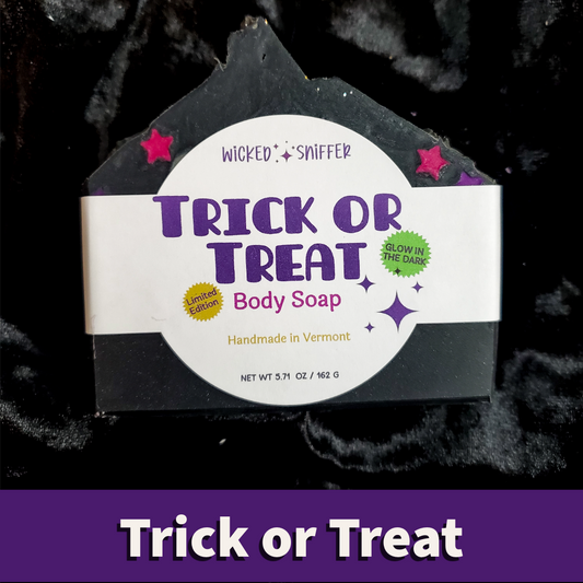 A house-shaped bar of Wicked Sniffer 'Trick or Treat' body soap on a black textured background, with a purple banner at the bottom reading 'Trick or Treat'.