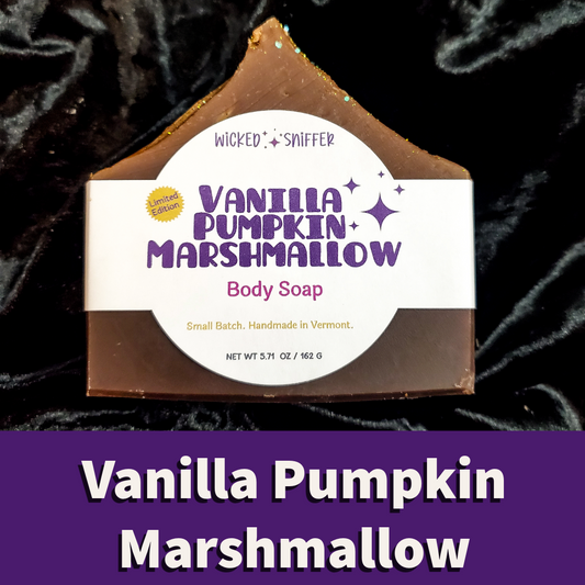 A house-shaped bar of Wicked Sniffer Vanilla Pumpkin Marshmallow body soap with a white paper label, set against a black velvet background with a purple text banner at the bottom.